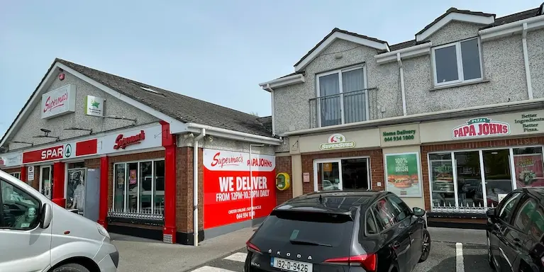 Storefront image of Supermac's & Papa John's Mullingar with signage clearly visible of delivery availability