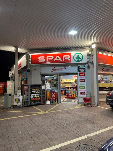 Storefront image of Supermac's Monksland Athlone with Supermac's signage clearly visible. Located within a service station with a Spar convenience shop also on premises.