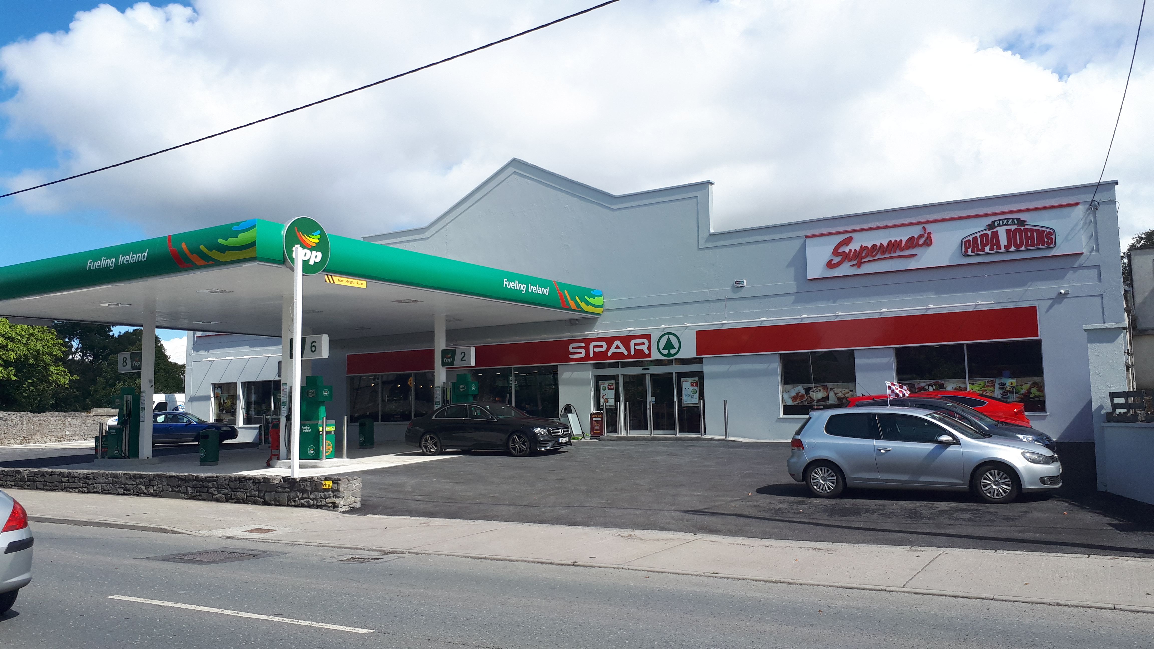 Storefront image of Supermac's and Papa John's Birr with signage and parking clearly visual