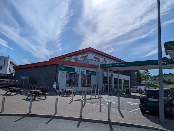 Supermac's and Londis at Foley's service station in Donegal, Ireland. Features a large modern building with grey stone and red accents, prominent 