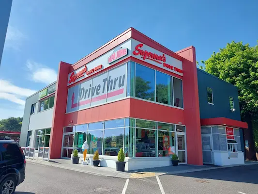 Exterior view of Supermac's & Papa John's in Tivoli, Cork with signage clearly visible for Supermacs, Papa John's and it's Drive Thru service.